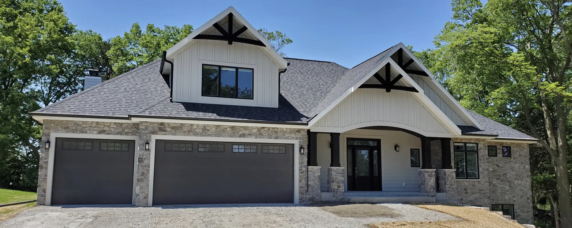 white exterior with black accents and gray toned stone